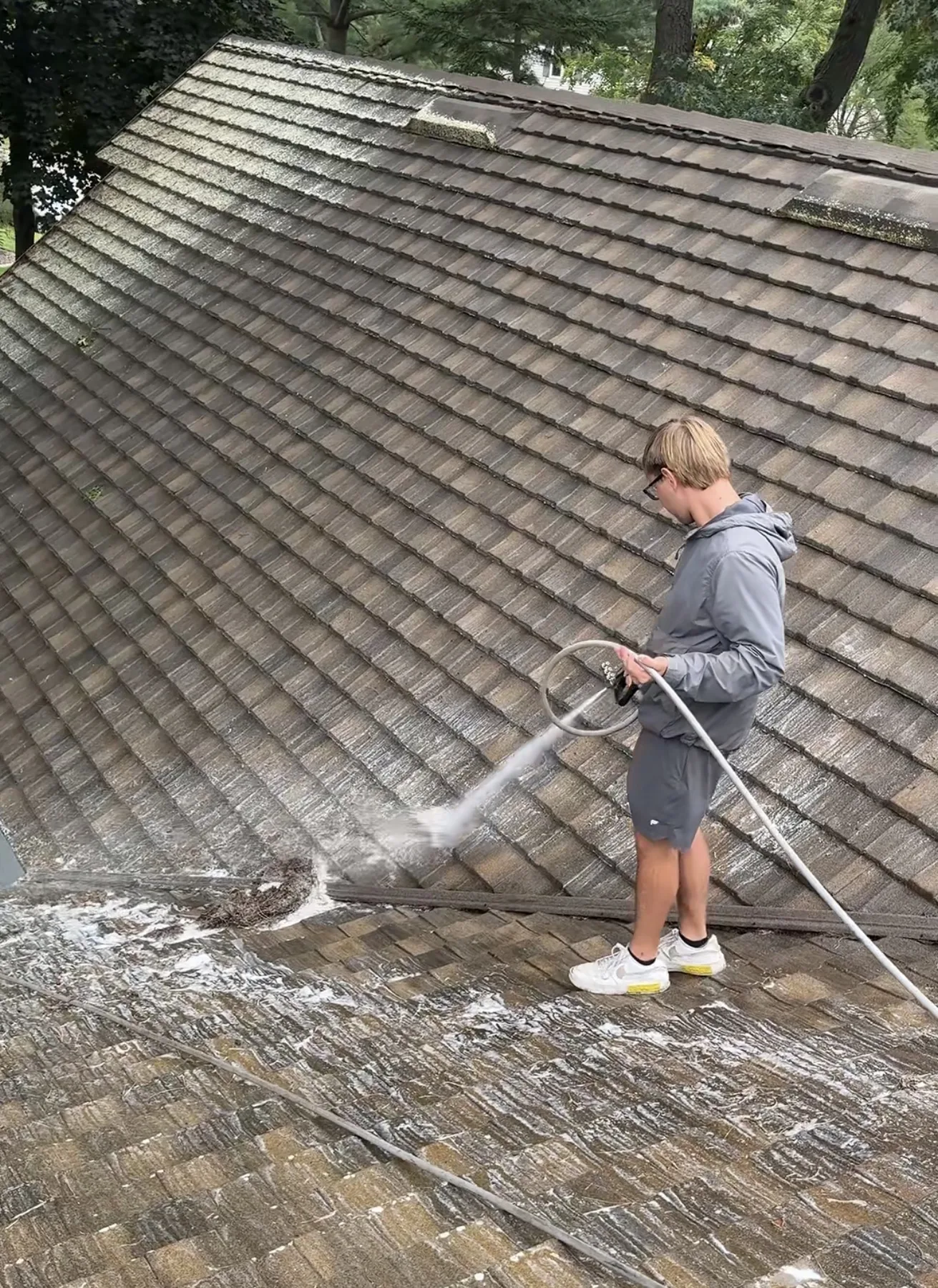 Roof washing service removing organic buildup from Wisconsin shingles